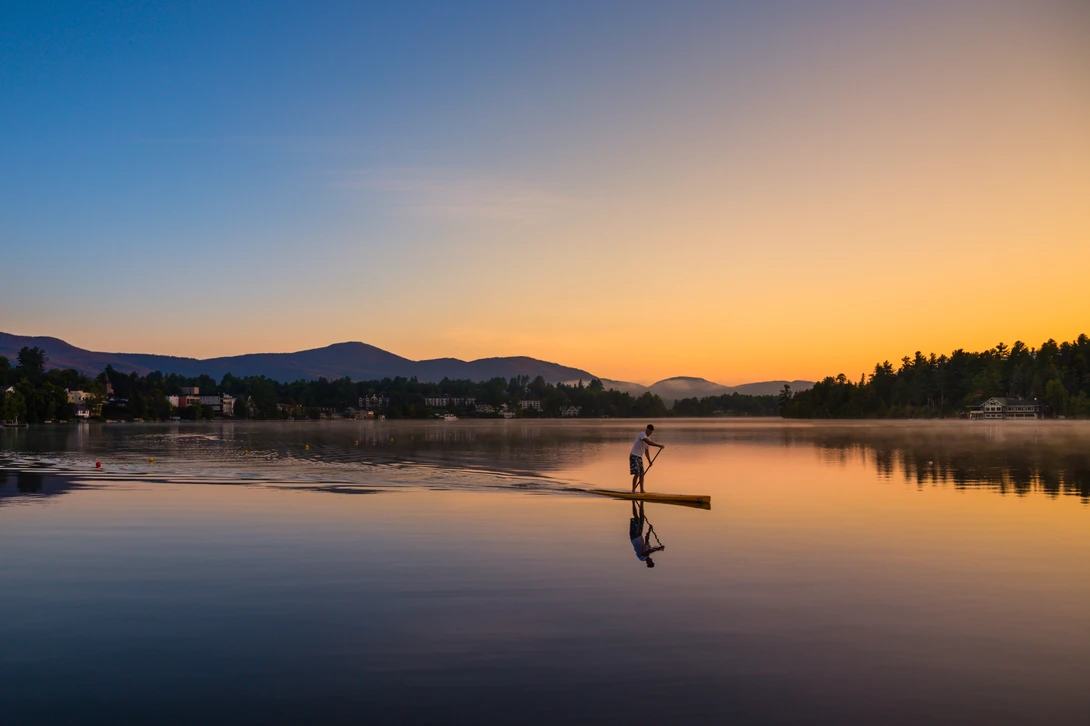 standing paddleboard sunrise mirror lake photo