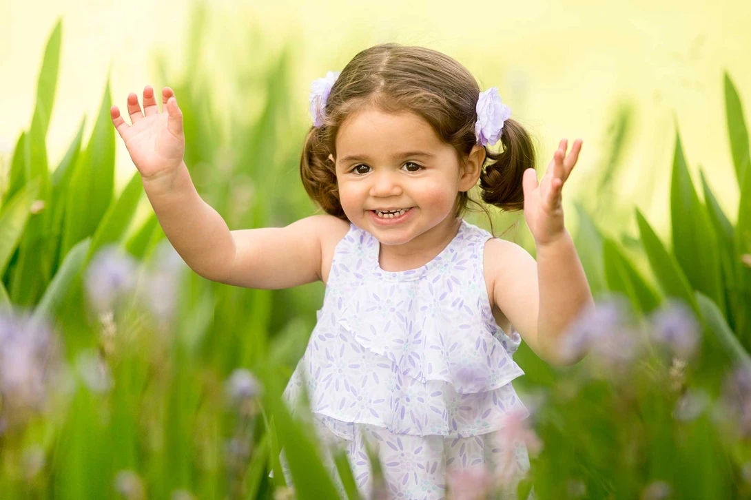 girl playing in flowers