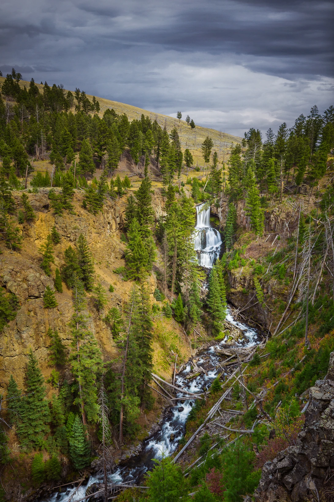 cloudy day shot of undine falls in yellowstone national park