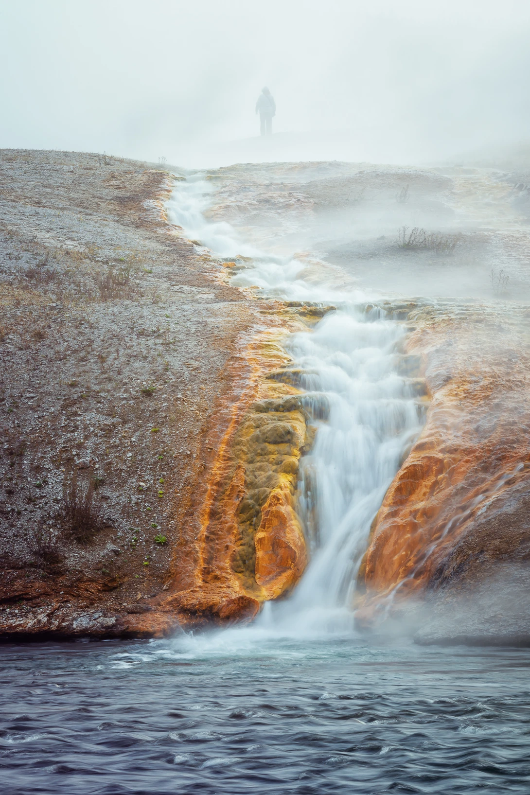 Shot of a hot spring with a silhouette.