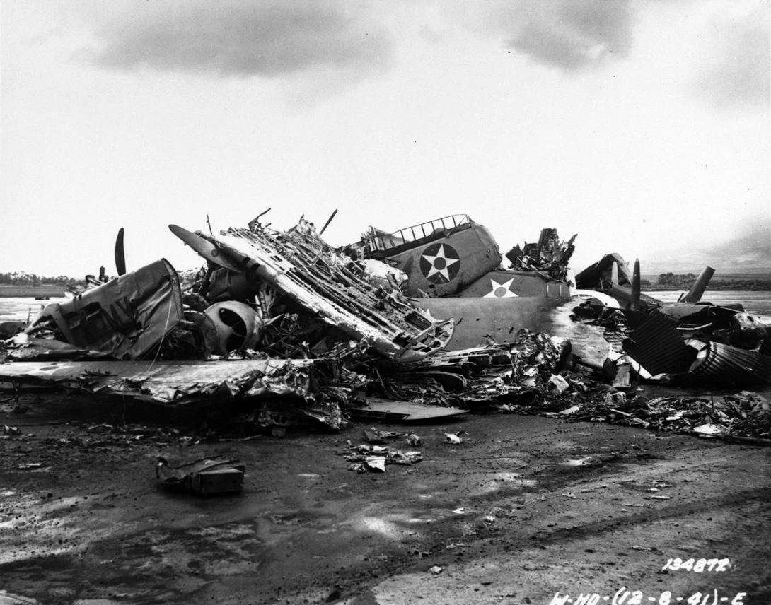 "Destroyed U.S. Army aircraft at Wheeler Field, Oahu, during post-attack cleanup activities. P-40 pursuit planes are among the types present."
