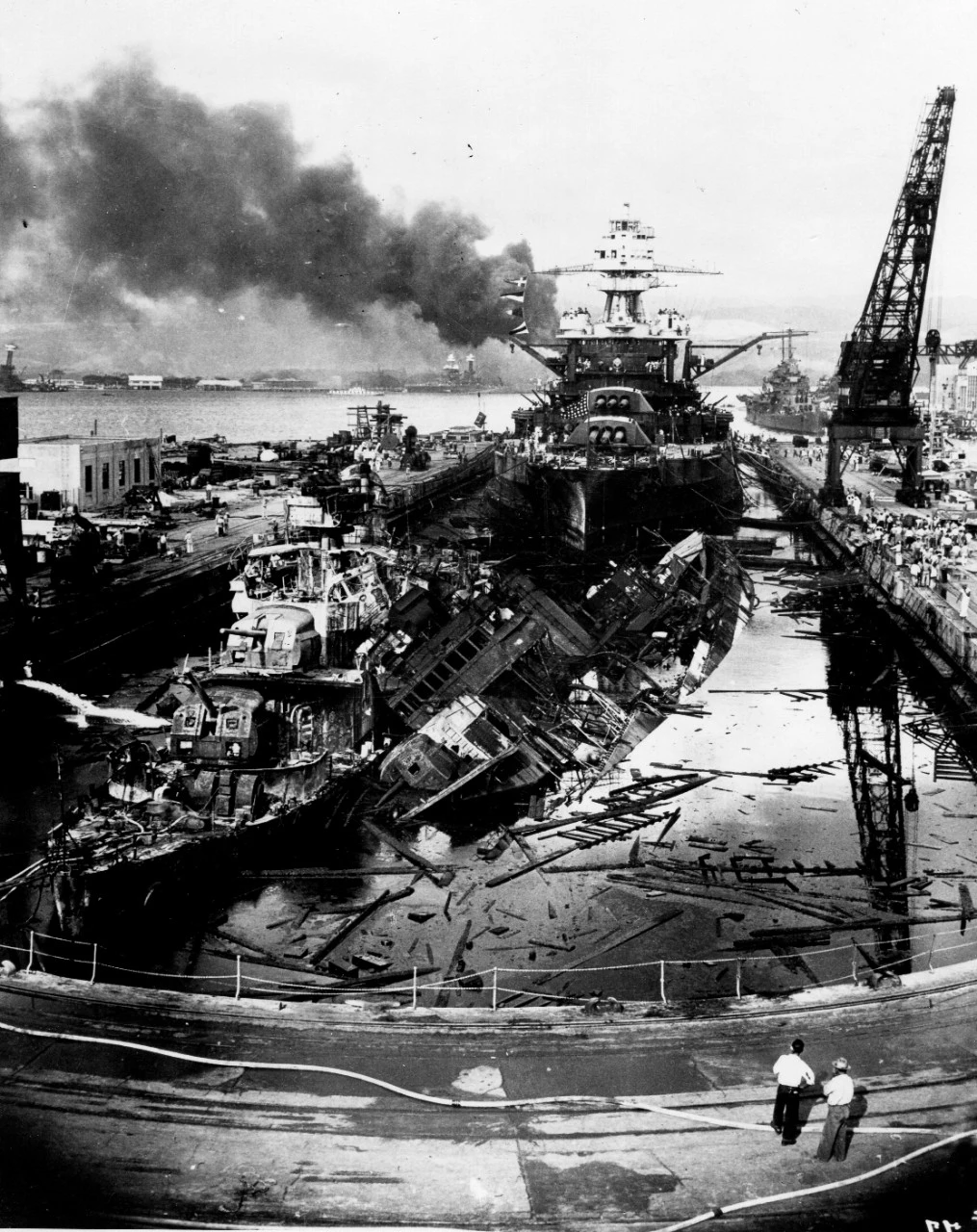 Here are the wrecked destroyers USS Downes and USS Cassin at the Pearl Harbor Navy Yard after the attacks were over. This image has been attributed to Navy Photographer's Mate Harold Fawcett