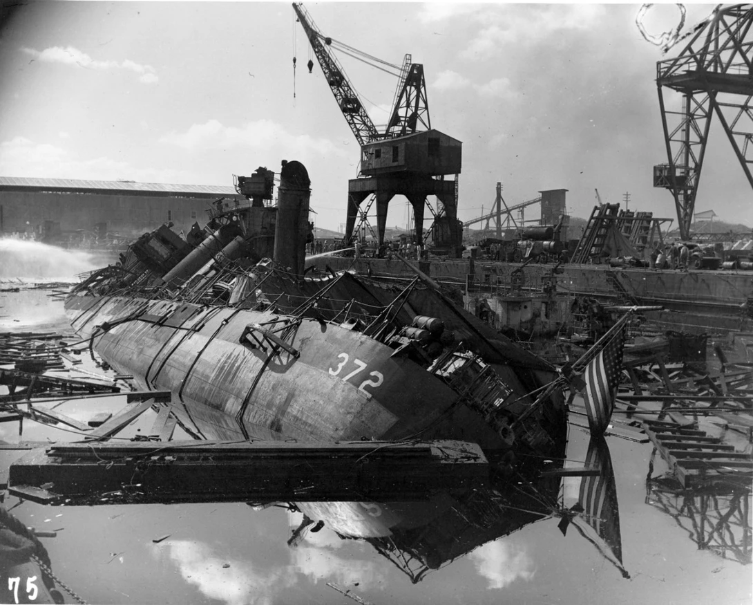 USS Cassin burned out and capsized against USS Downes after the attack. It's hard to imagine the time and effort required to clean up the wreckage from these massive ships. 