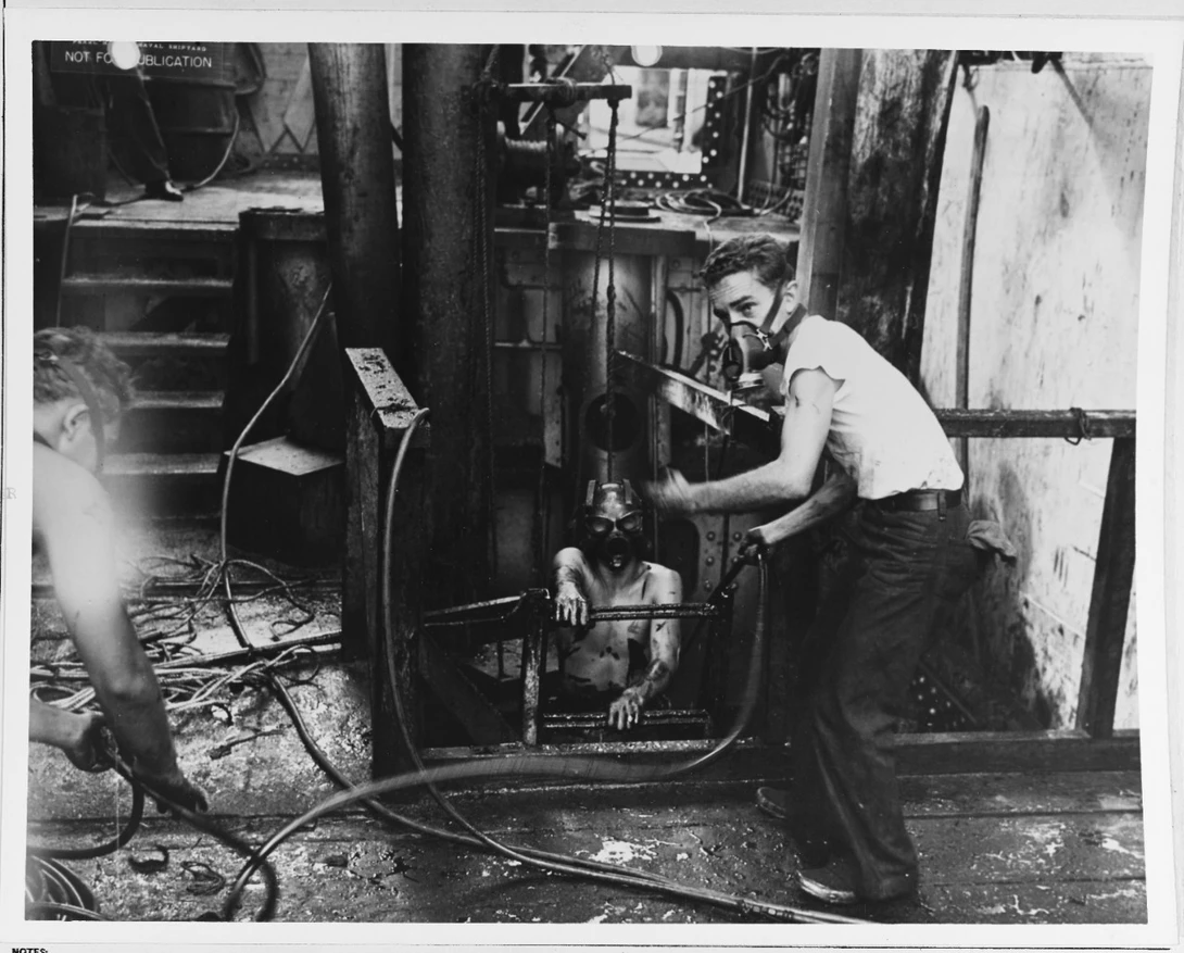 I didn't see many portraits in the archives, but here are a couple. "Divers emerging from a gas-filled compartment aboard one of the ships undergoing salvage, after the 7 December 1941 Japanese raid. Note oily conditions, and face masks worn by the men."