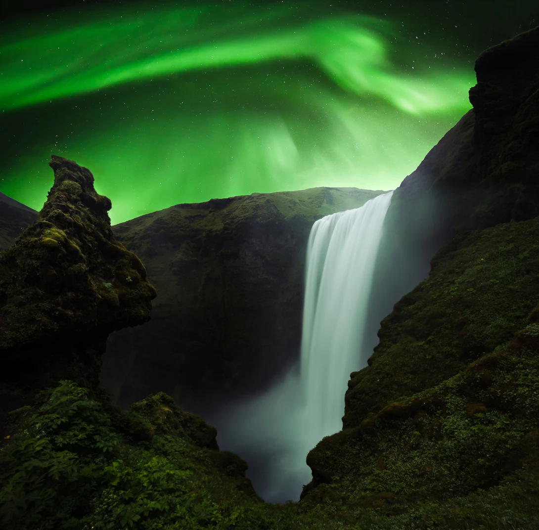composite of skogafoss and aurora