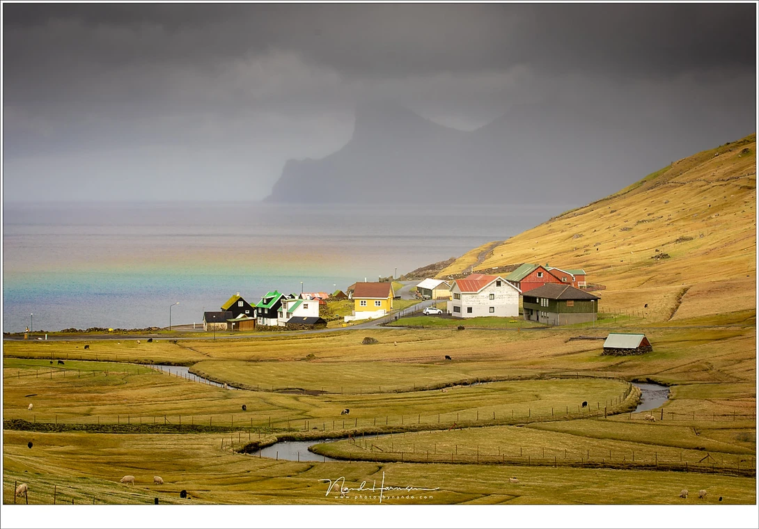 With the sun high above the horizon this rainbow appeared just above this small settlement at the Faroe Islands (Canon 5D4 with 90mm | ISO200 | f/9 | 1/125)