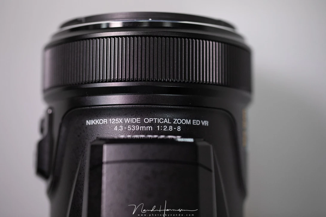 The focal length of this lens is 4.3 mm - 539 mm. With the 1/2.3 inch sensor of the Coolpix P1000 this is equivalent to 24mm - 3000mm on a full frame sensor. It comes to the expense of an aperture that varies between f/2.8 and f/8, among some other thing