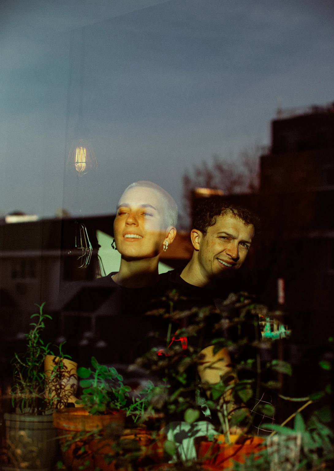 A couple photographed through their window pane in Brooklyn for the Come To My Window during COVID-19