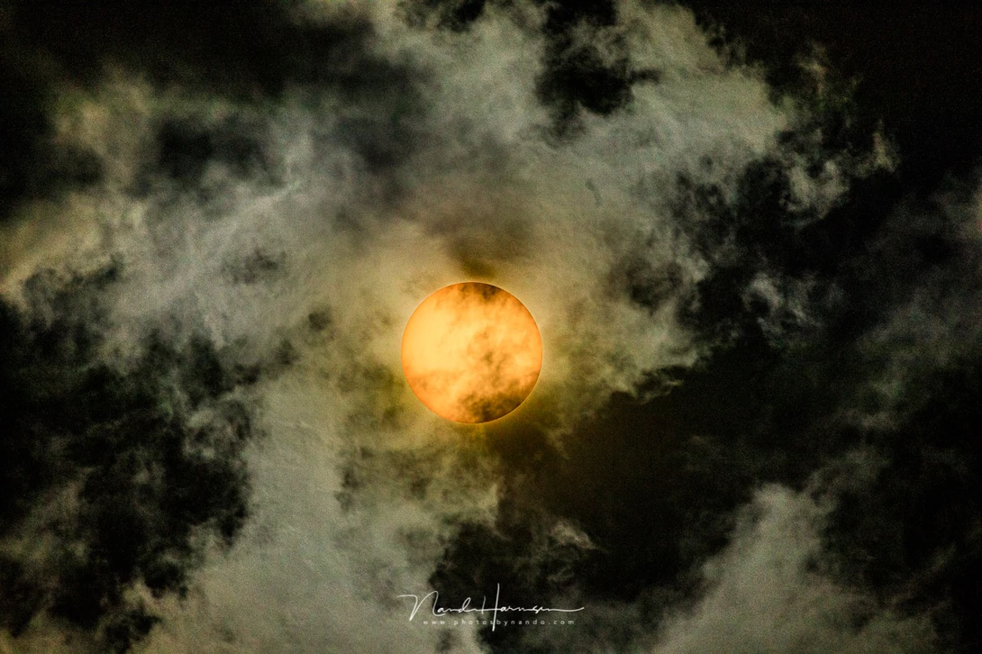 The sun behind clouds. The black parts are in white fluffy clouds in reality, which turned completely black by the filter. It gives an idea how bright the sun and white parts are, and how much light the filter holds (Canon EOS 5D4 + EF100-400mm @ 400mm + 