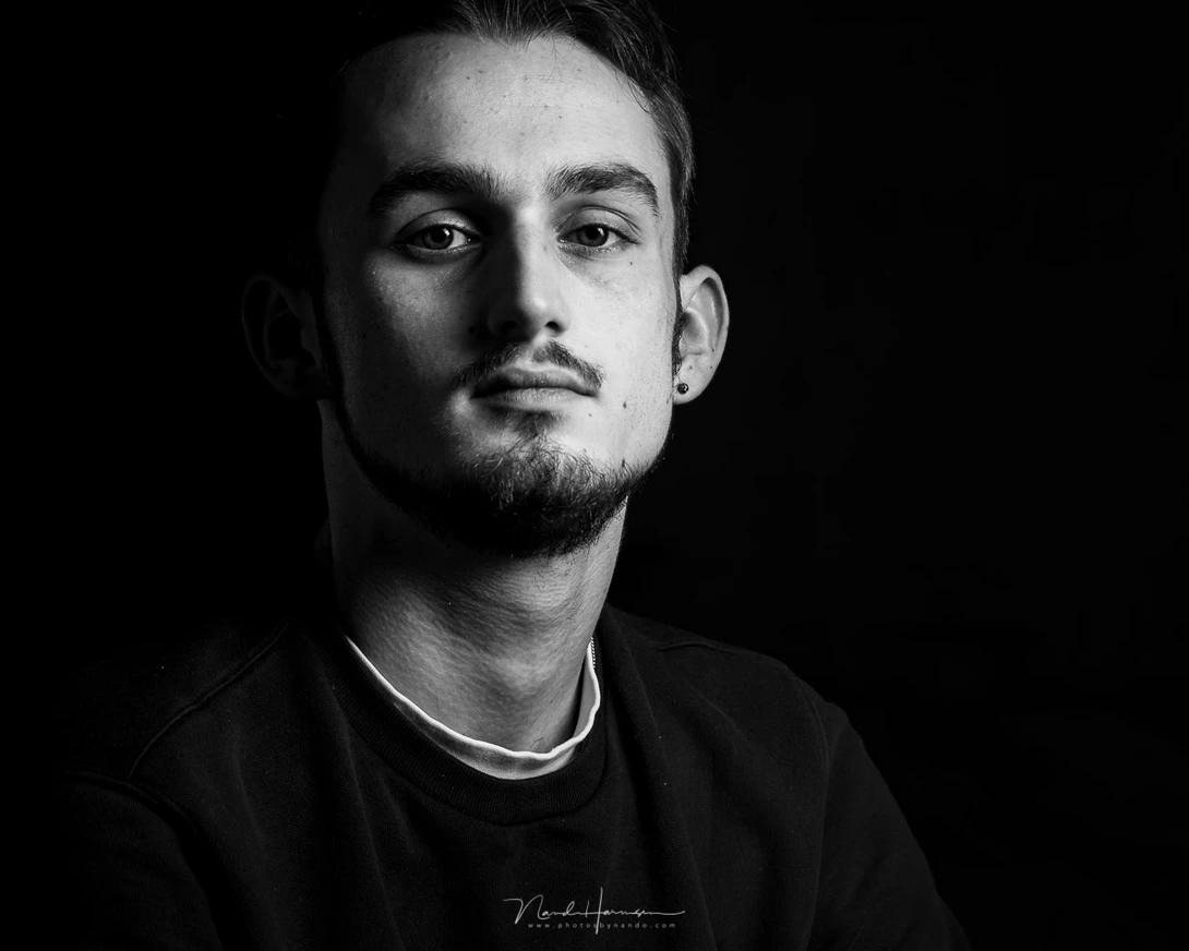 Again a portrait in my living room studio, this time with my son. I used a 1x3" striplight and a reflector.
