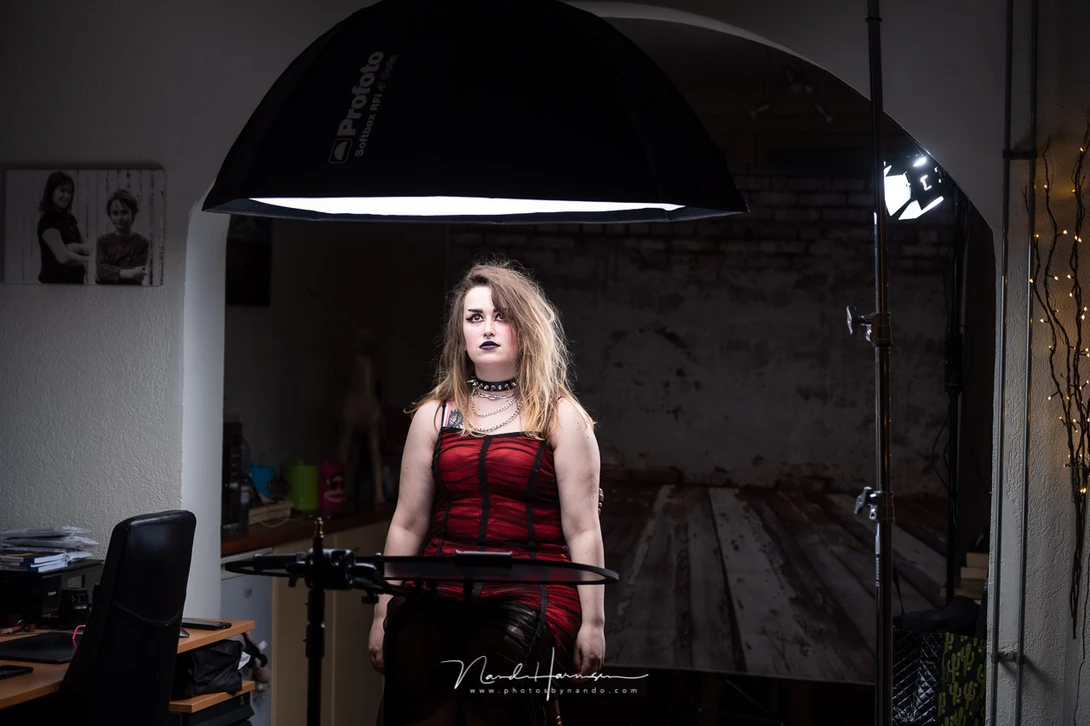 My daughter Madouc in the living-room-studio for a gothic look photoshoot, looking at the large octabox above her, wondering if it&nbsp;will&nbsp;won't fall down.