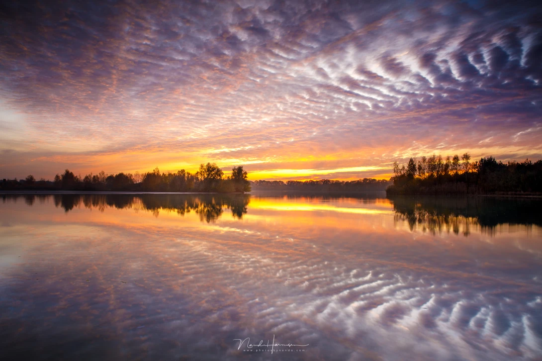 These clouds during evening twilight are reflecting almost perfectly.