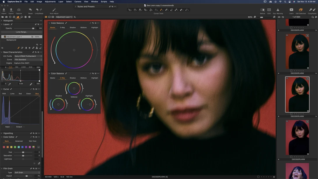 Screenshot of photo editing software showing color grading interface with woman's portrait against red background.