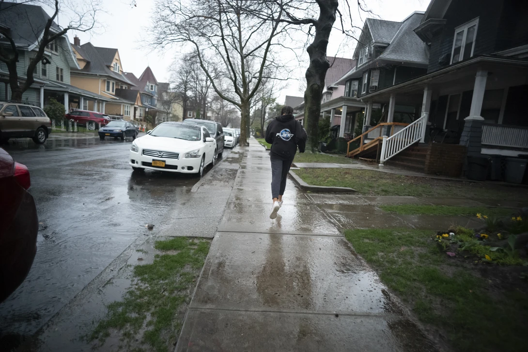 Girl running in the rain.