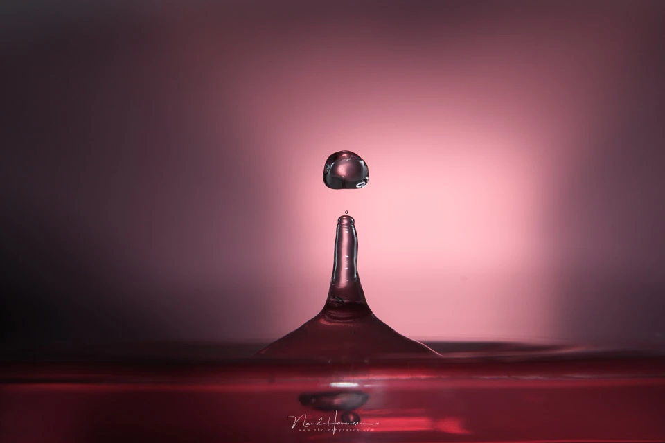Water droplets, shot with a flash and a color gel. I used a remote to trigger the camera and not an automated system of sorts. You need a good timing and a bit of luck.