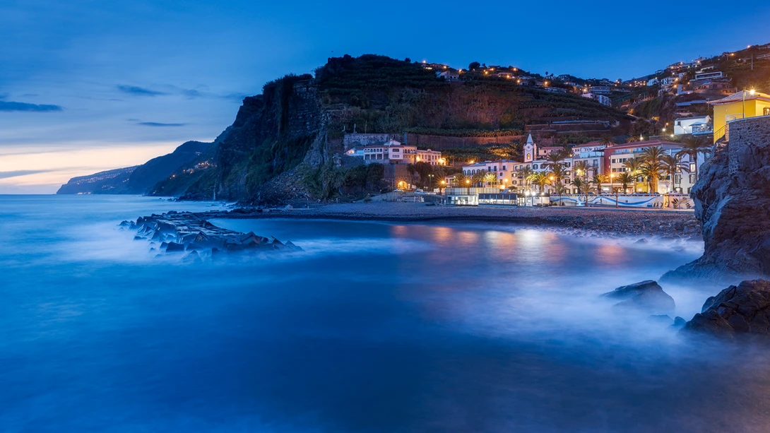 Illuminated Coastal Town With Blue Sea and Blue Sky