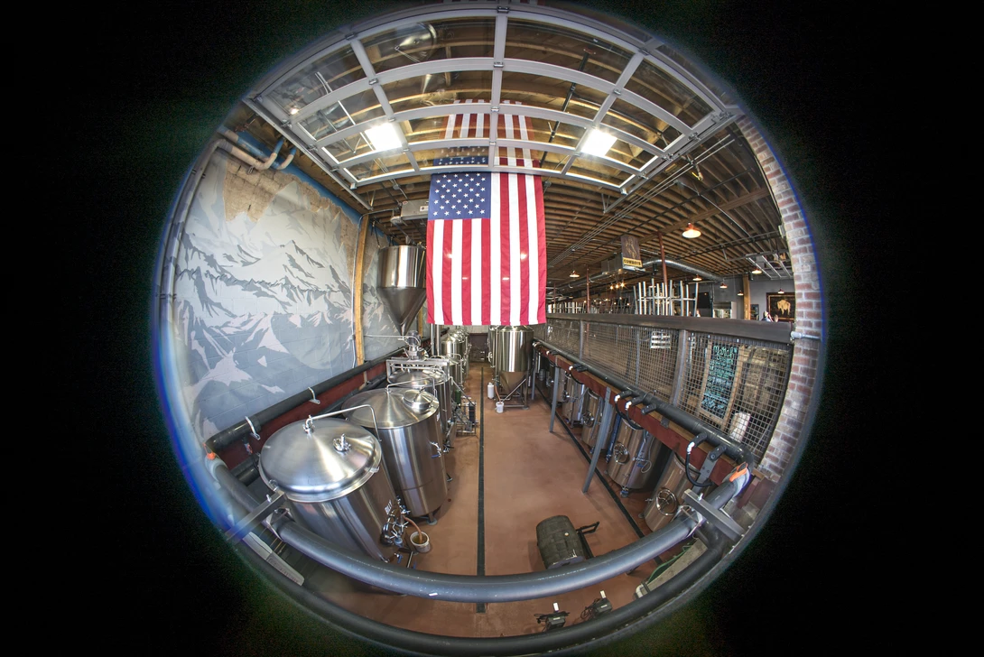 American flag hanging in an industrial hangar photographed with a wide-angle fisheye lens.