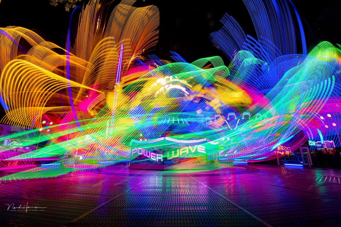 Using a slow shutterspeed will help to capture the movement of the fairground attractions. The results can be quite surprising.