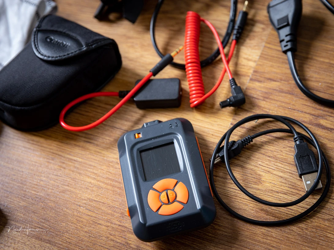 A small Miops trigger and a Trigger Trap. Both do the same thing, but you only need one. Although the Trigger Trap doesn't take much space, it's unnecessary to have it in you bag if you have the other one.
