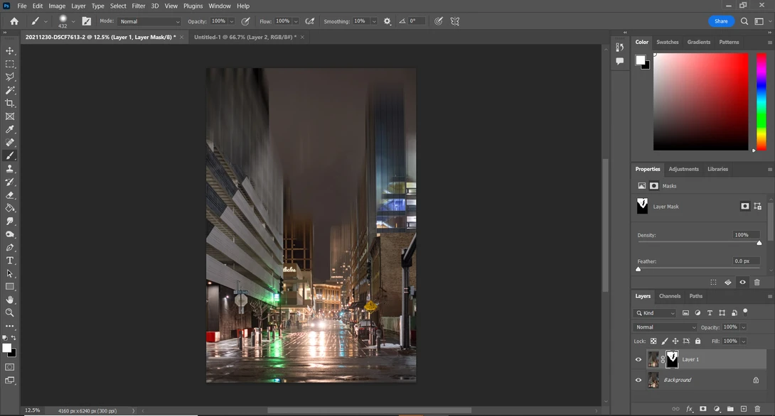 Screenshot of photo editing software displaying a wet urban street at night with car light trails and building reflections.