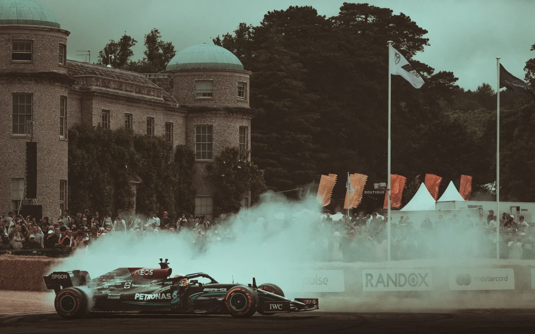 Esteban Gutiérrez performs a burnout for the crowd in front of Goodwood House at the 2022 festival of speed.