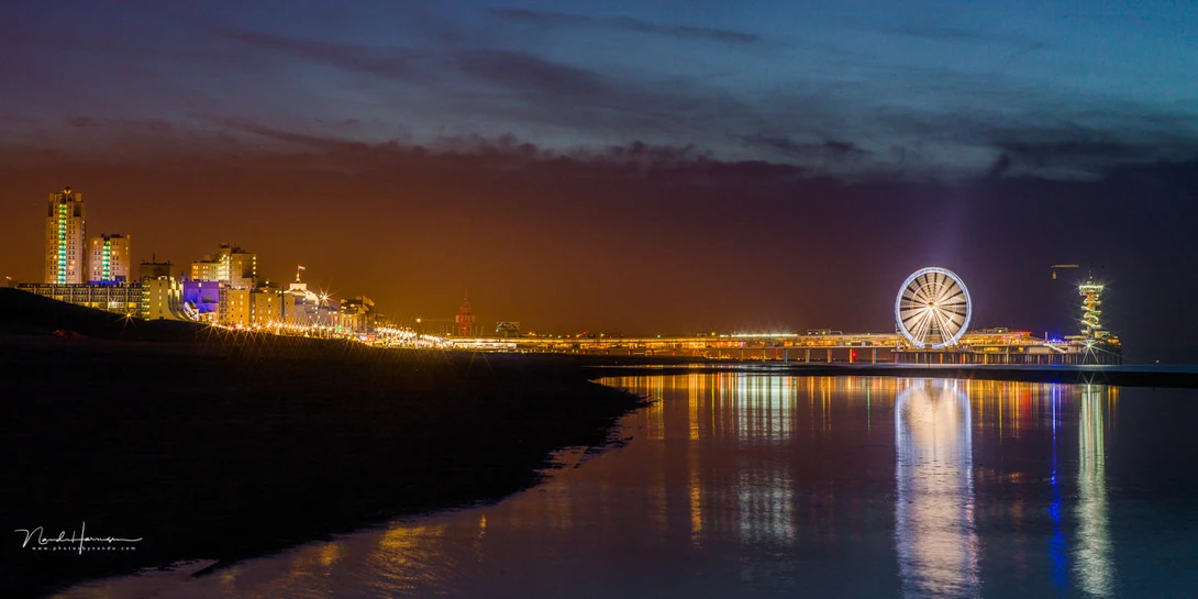 A somewhat longer expose flattened water on the beach, providing a nice reflection of the lights. Would you think of using a reflection for this kind of image?