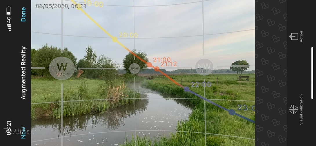 Landscape photo with augmented reality overlays showing sun position, compass, and time data.