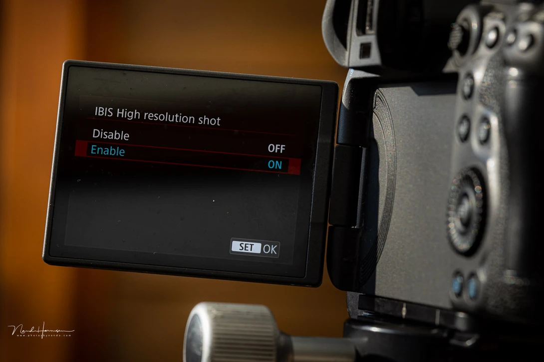 Camera LCD screen displaying IBIS High resolution shot menu with Enable/Disable and OFF/ON options.