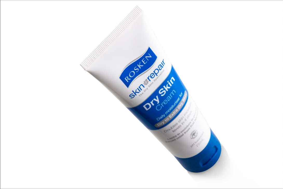 Tube of blue and white skincare product shot at an angle against a white background.