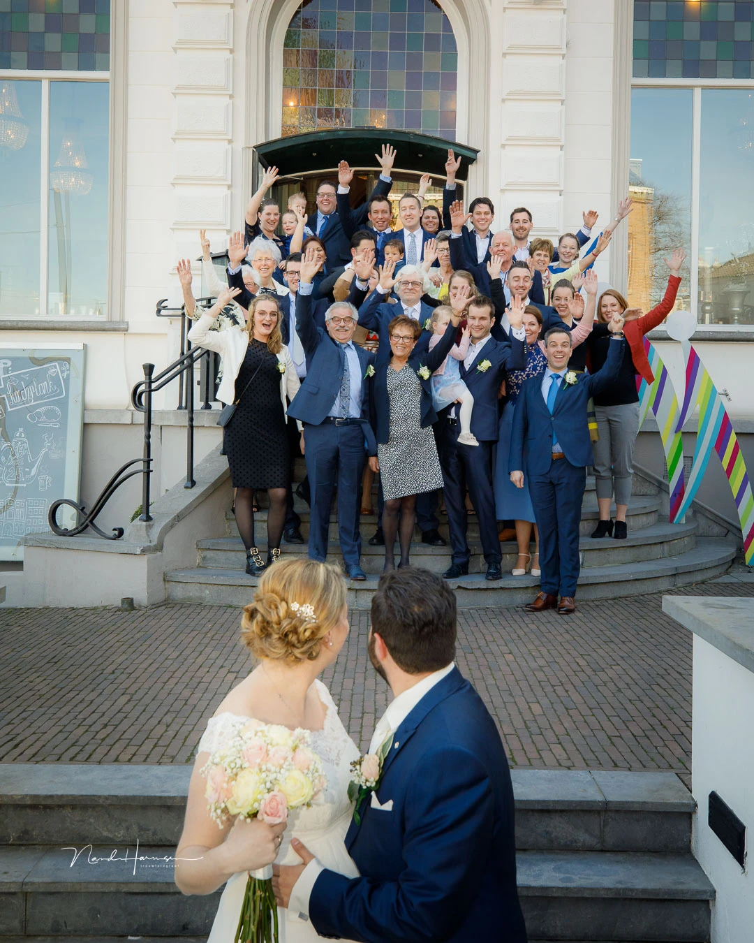 A wedding group, photographed with 35mm. It might be tempting to use a wide-angle lens, but it would have made the group too small relative to the wedding couple. I like the relative size between the wedding couple and the wedding group that is achieved b