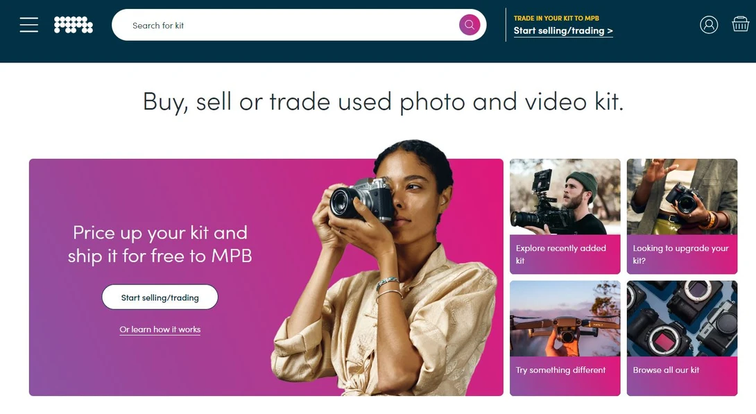 Photographer holding a vintage film camera against a vibrant magenta background.