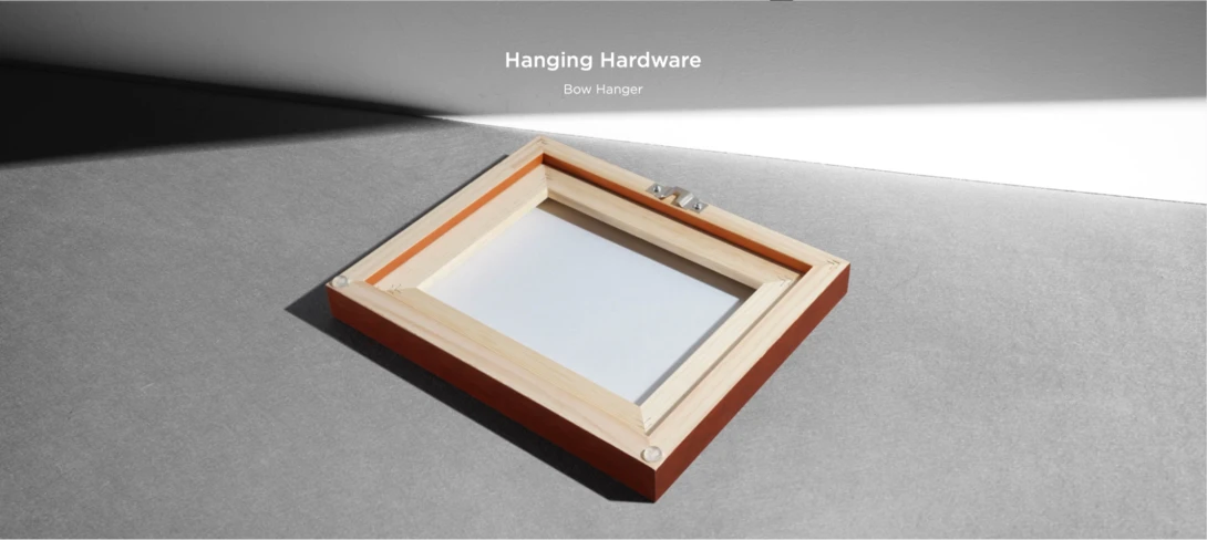 Wooden bow hanger with cream-colored mounting hardware against concrete surface.
