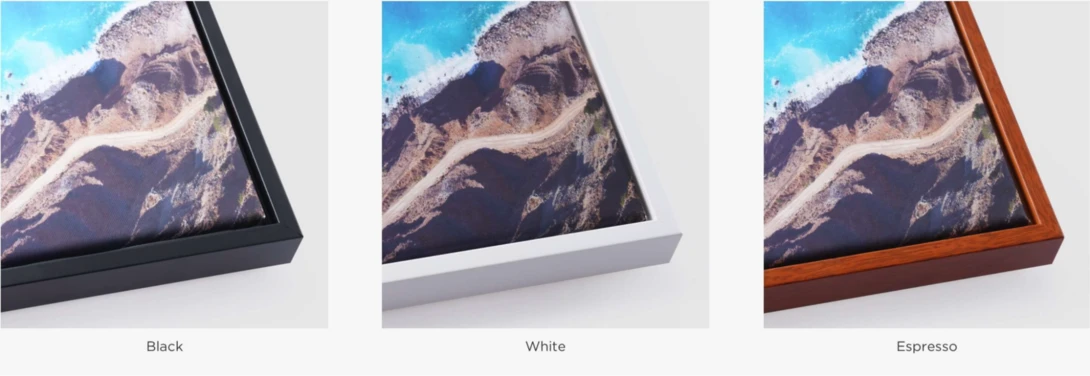 Three framed aerial landscape photographs displayed in black, white, and espresso wood frames.