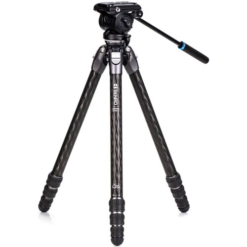 Professional video tripod with fluid head and carbon fiber legs extended against white background.