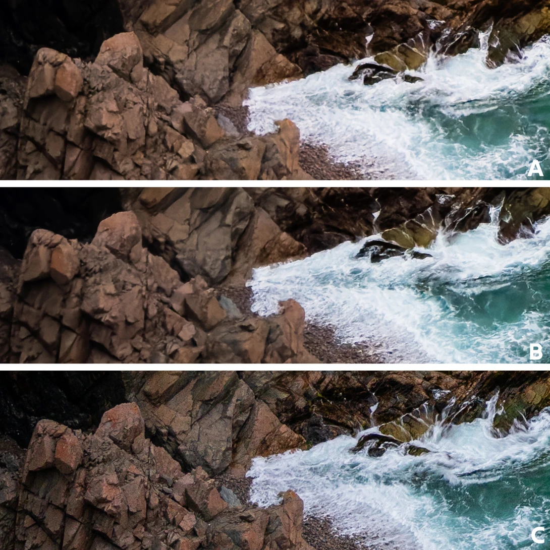 Rugged coastal rocks with turquoise waves crashing against the shore.