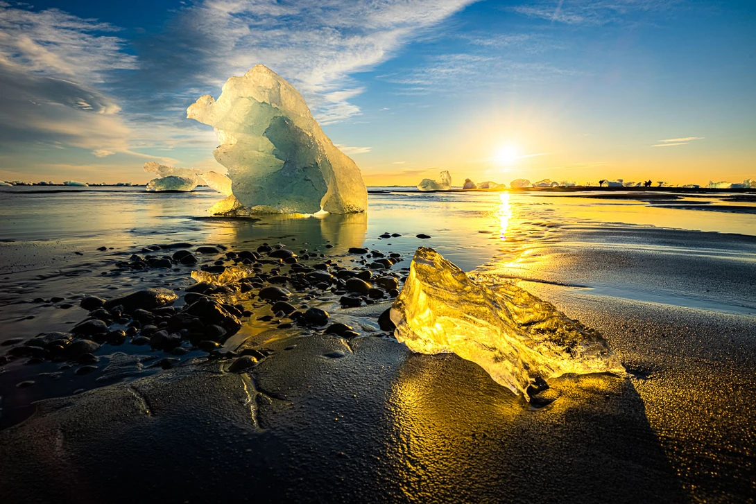 Ice on Diamond Beach in Iceland. The two ice blocks are positioned in such a way that it keep the balance. Although not used when composing the composition, it can fit in a rule of third.&nbsp;