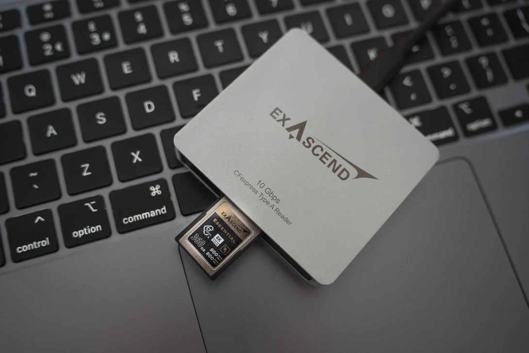 Exascend memory card and card reader displayed on a laptop keyboard.