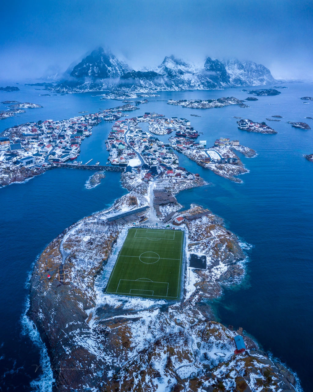 The famous football field at Henningsvær, Lofoten, Norway. This can't be photographed in such a way unless you have a drone.