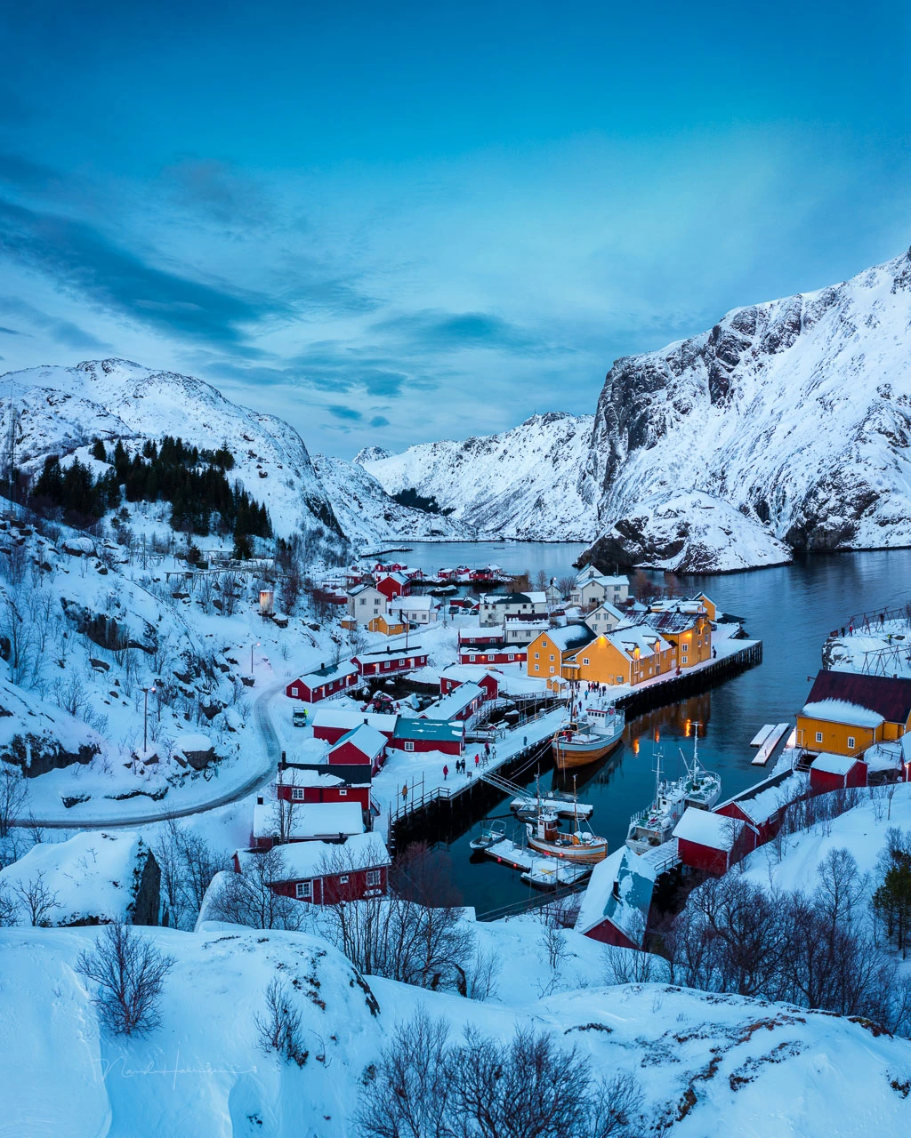 The village of Nusfjord, Lofoten, Norway. It's impossible to climb to this vantage point, but a drone can. This is captured only a few meter above the snow.
