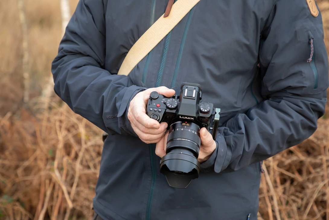Holding the Panasonic Lumix DC-G9 II. It's a great camera to use.