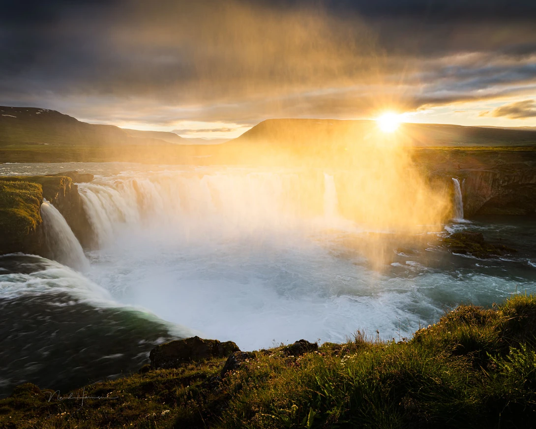 With wide angle and a small aperture, in many occasions focussing onto the horizon is perfect. The depth of field will bring more than enough in focus.