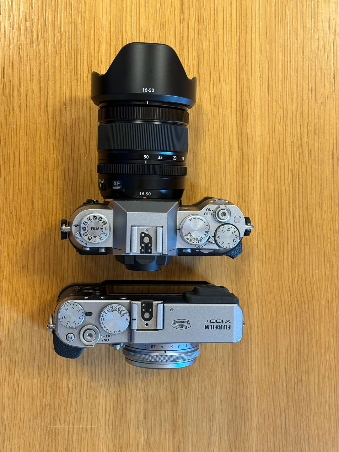 The X-T50 with the XF16-50mm f/2.8-4.8 R LM WR next to the old X100t for comparison.