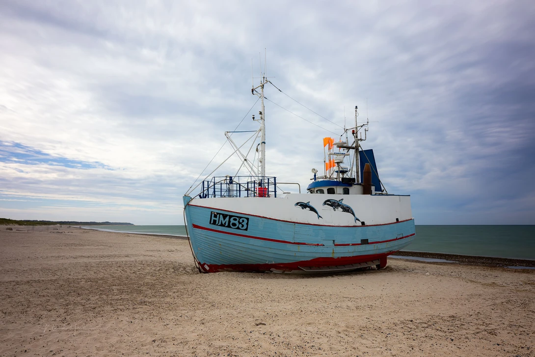A fishing boat on the beach in Denmark. The increased magenta color cast is due to stacking with the CPL filter. Avoid doing this.