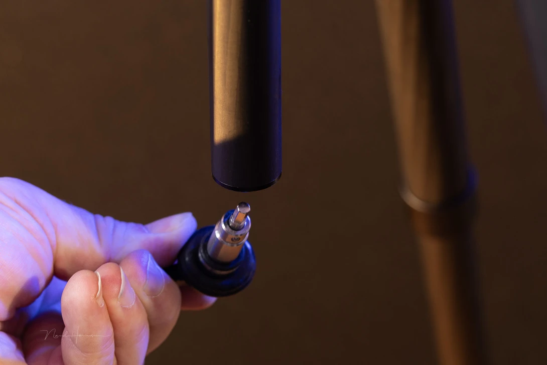 There is an allen key hidden in the center column. The hook itself can carry a lot of weight, eventhough it doesn't look that sturdy.