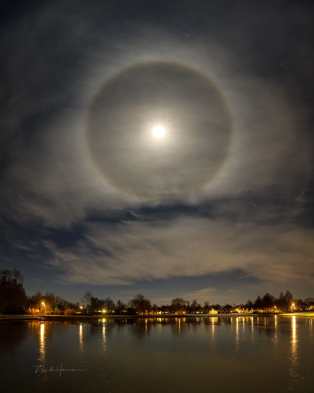 A moon halo. This is a vertical panorama which made it possible to incorporate the foreground and reduce the distortion of the halo.
