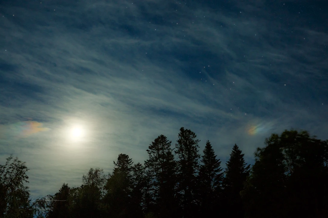 A rare sundog. There are also some iridescent clouds on the left.
