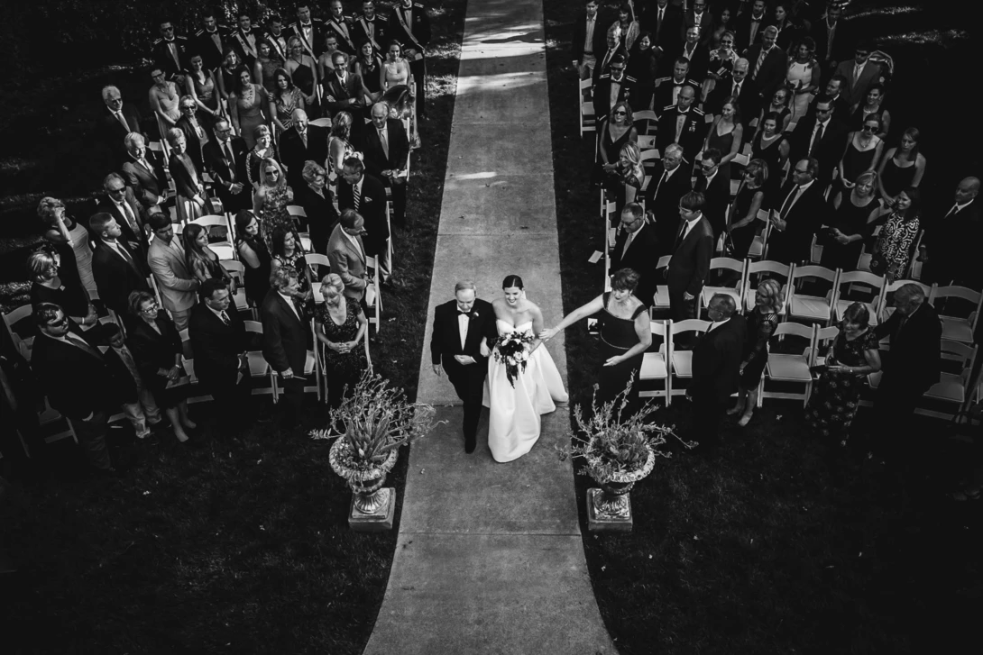 bride walks the aisle in a top-down shot for wedding photojournalism
