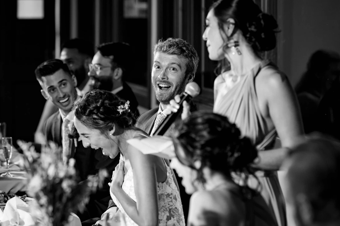 wedding photojournalism example of group reaction during toast