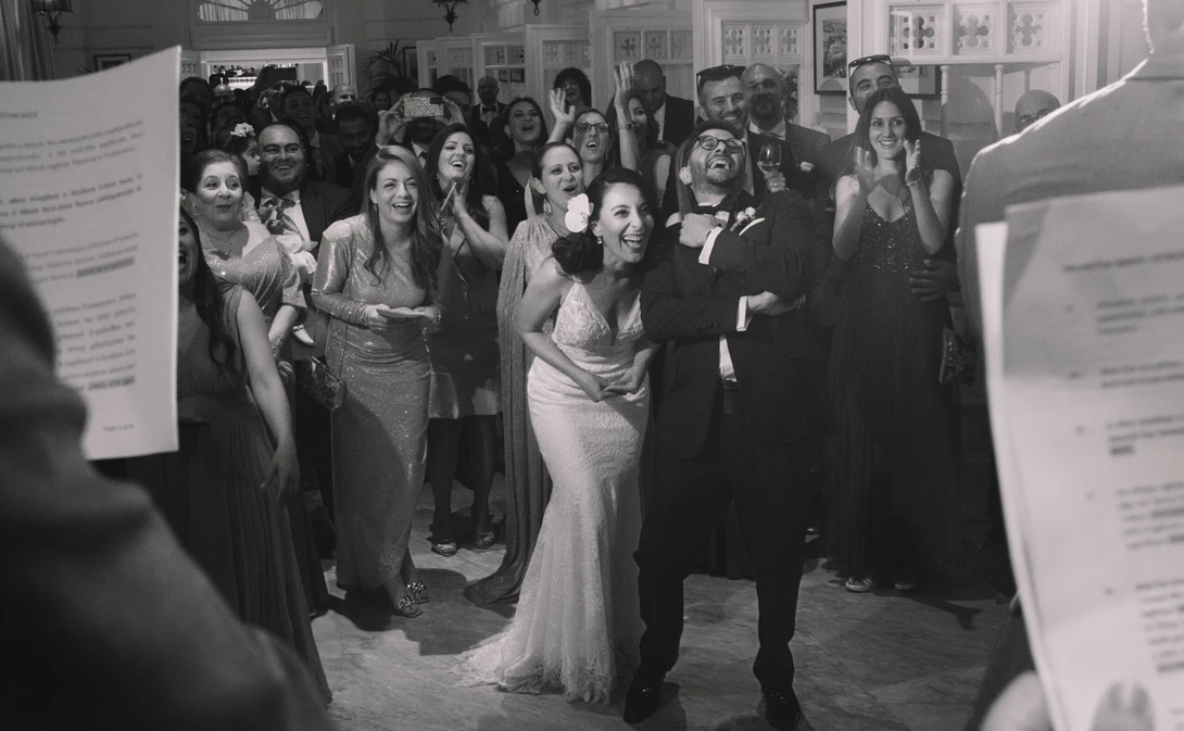 Bride, groom, and guests react to toast