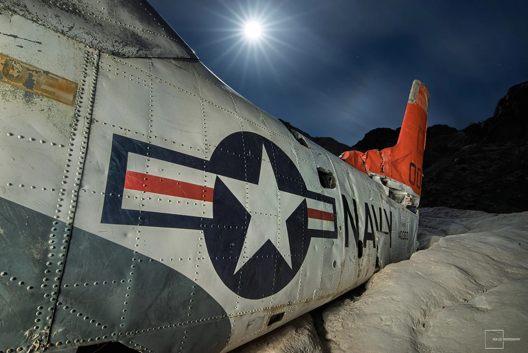 Underexposed photo of Navy trainer at night after processing
